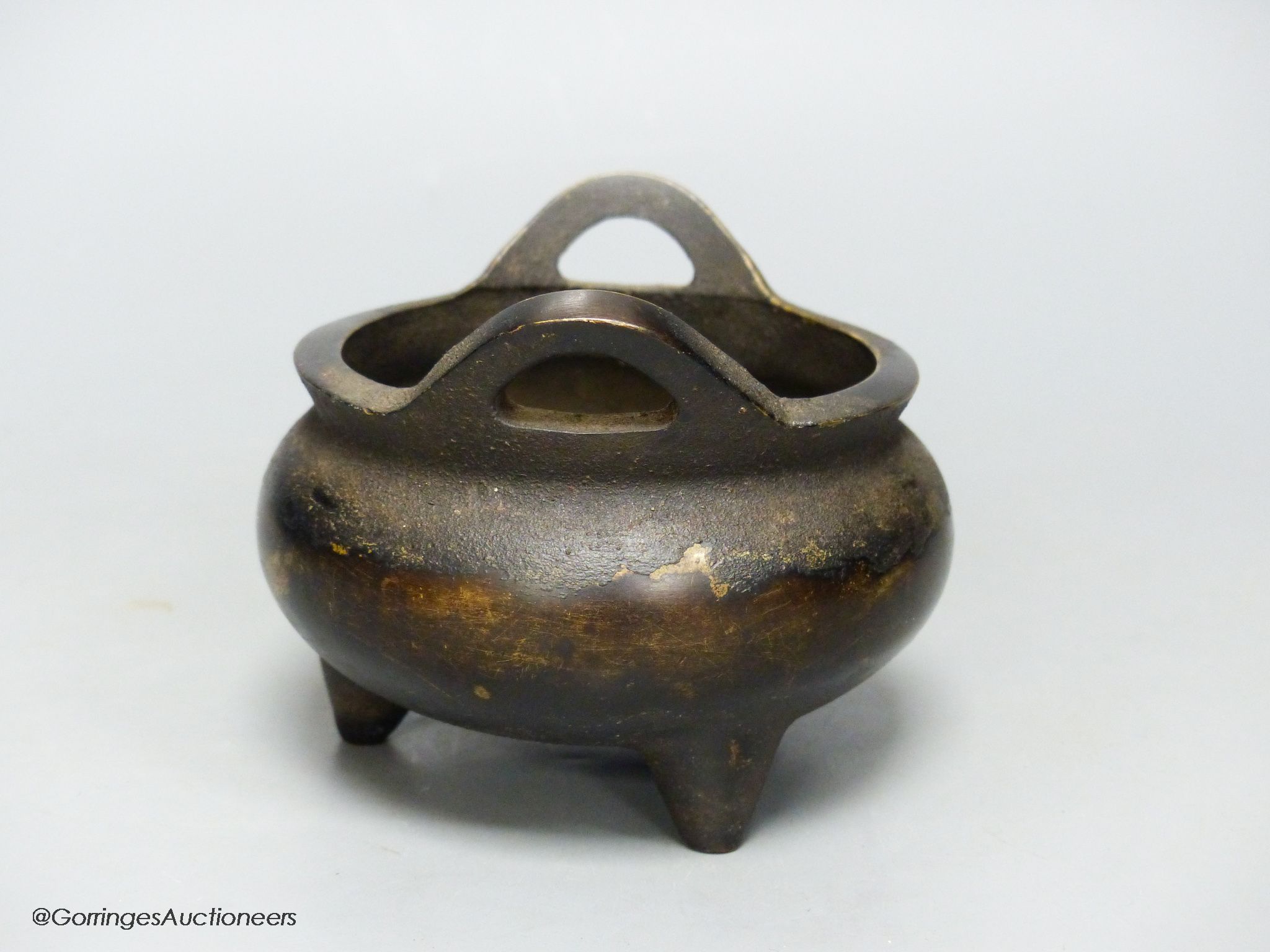 A Chinese bronze tripod censer, Xuande four character mark height 10cm